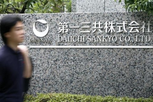 Man walks past a sign of Daiichi Sankyo Co., Ltd. at the company's head office in Tokyo